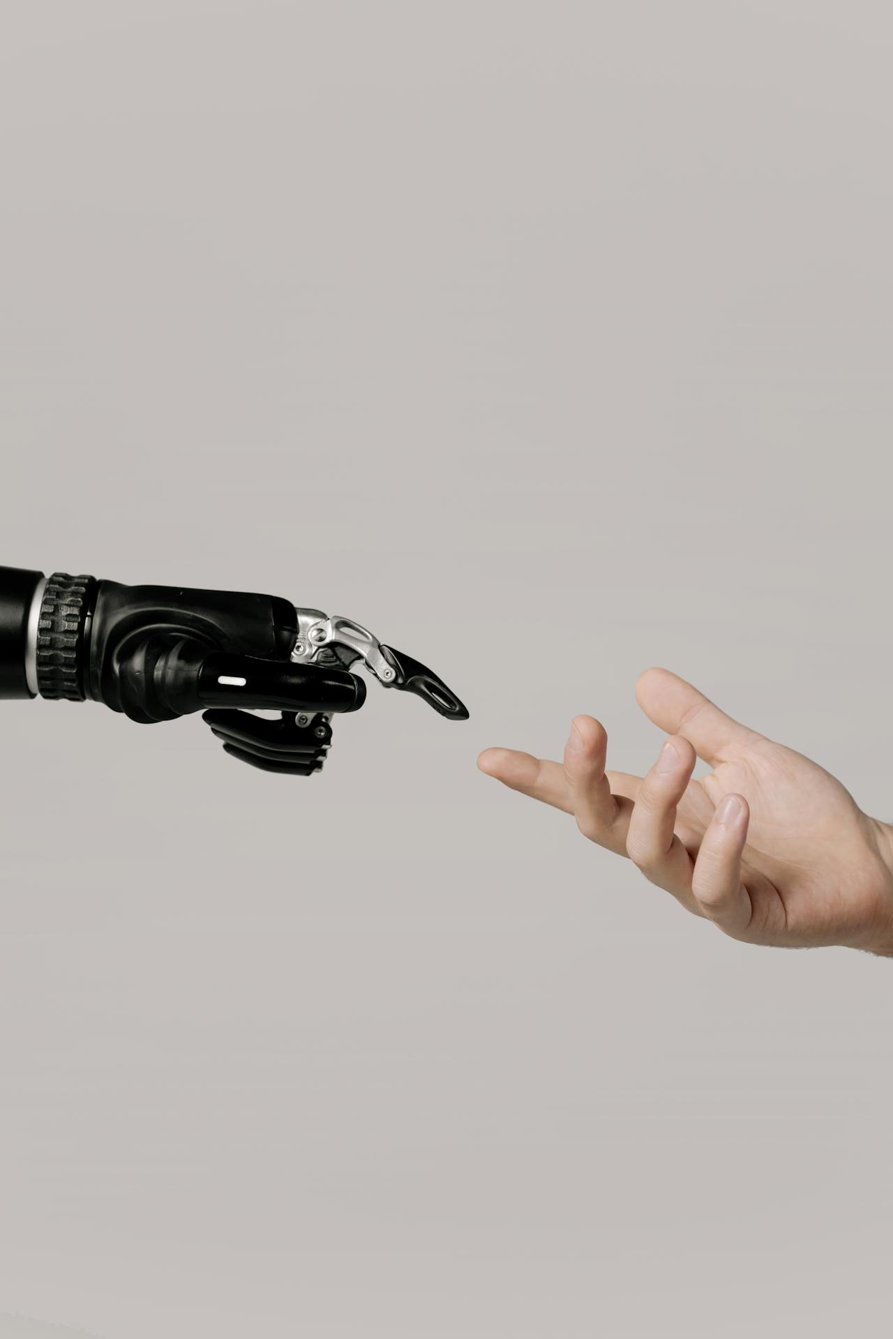 human and robot hand close to each other